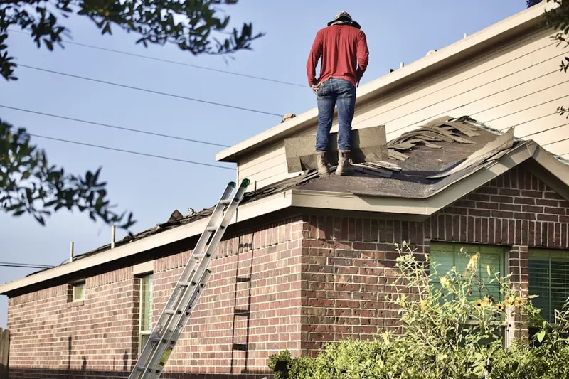 Professional roofer working on a residential roof in Rice Creek